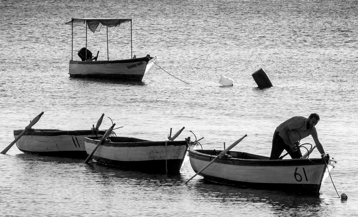 a black and white photo of two boats in the water