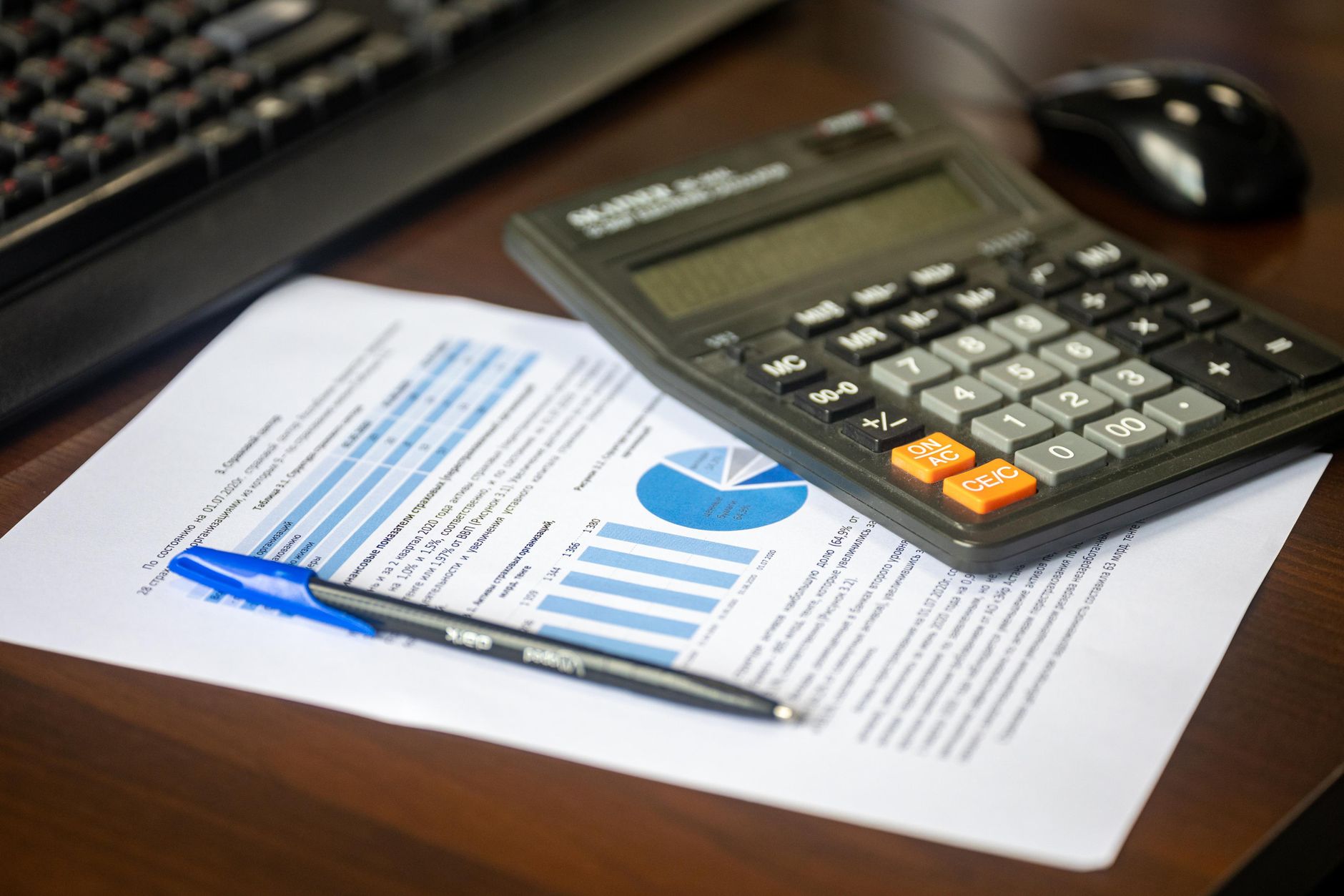 Calculator sitting on top of a printed financial document.